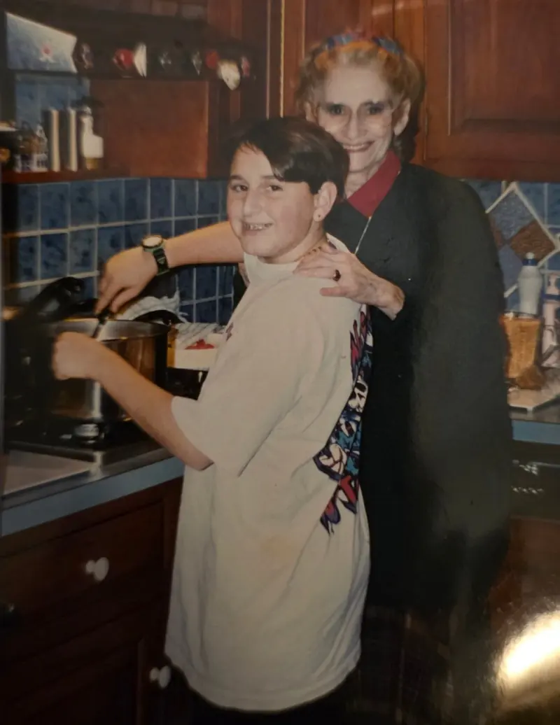 Young Joe with his grandmother in her kitchen