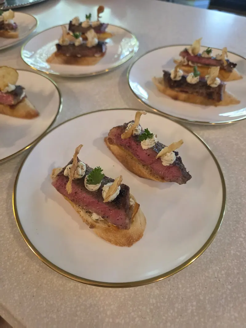 Beef crostini plated on gold-rimmed china
