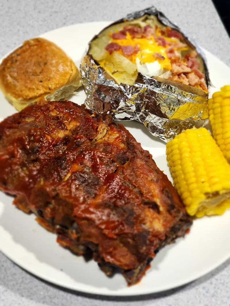Ribs, baked potato & corn