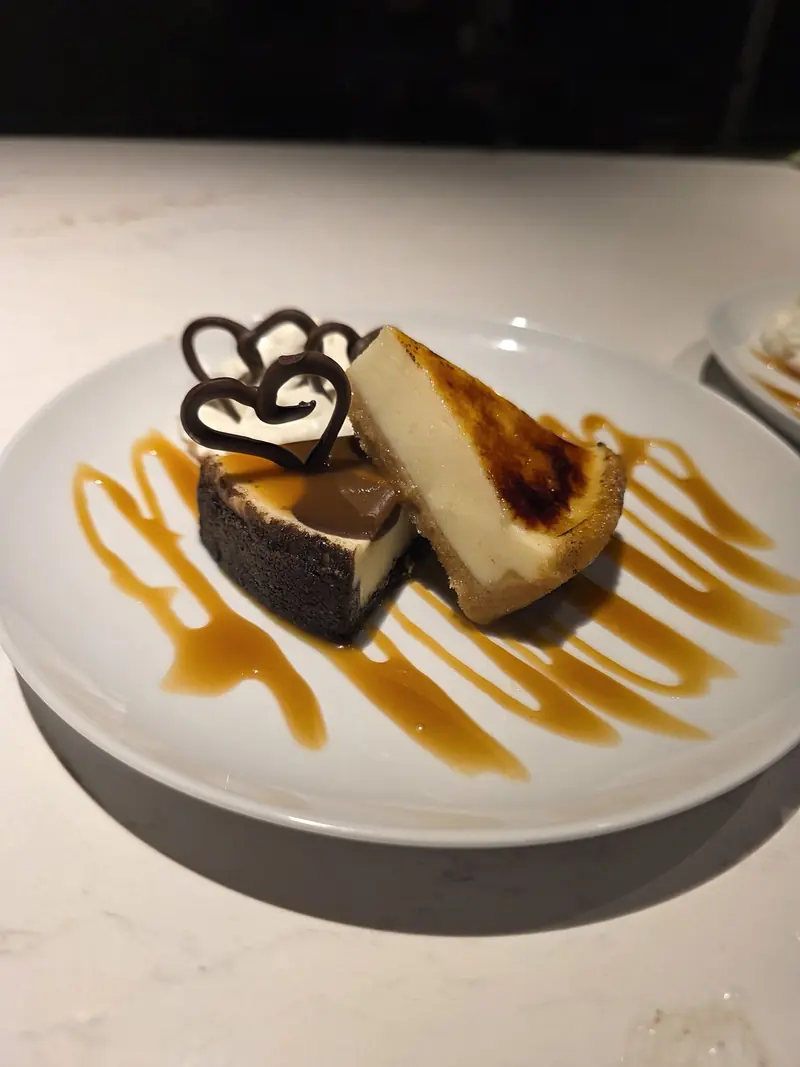 Plated dessert with a chocolate lattice garnish and caramel swirls on a white plate