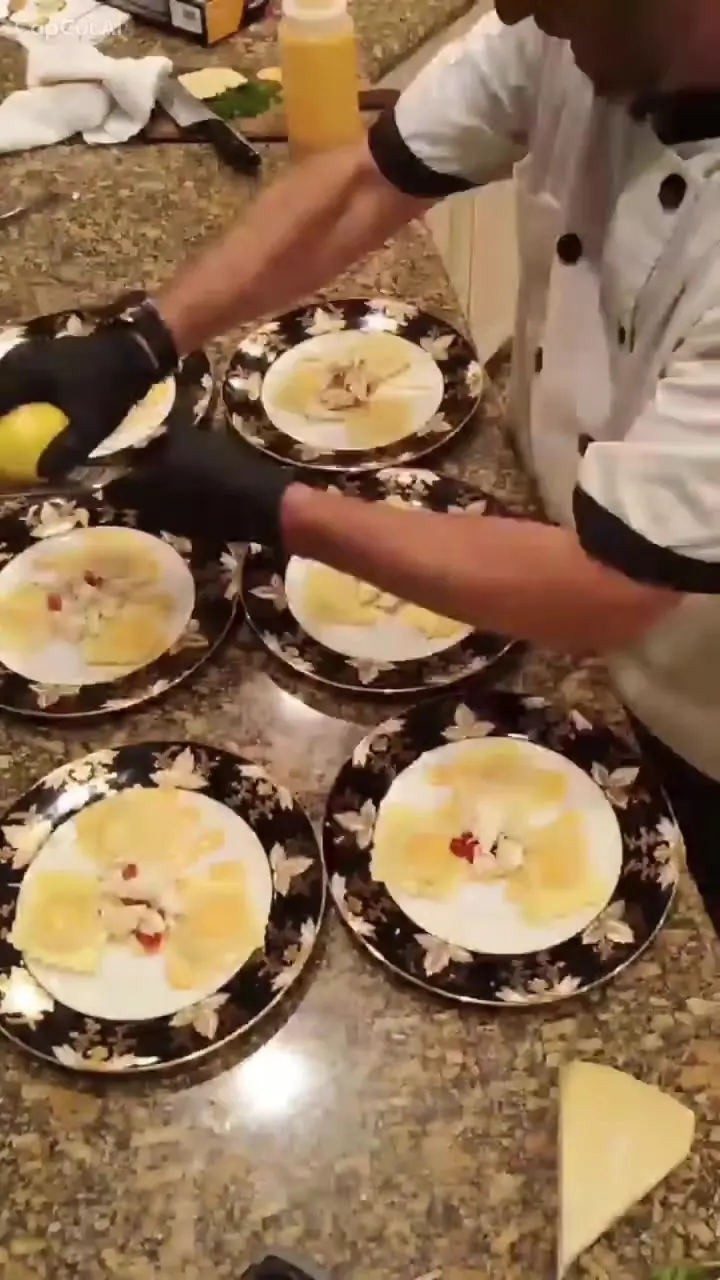 Chef Joe’s gloved hands plating a long run of ravioli plates, from his plating time-lapse video